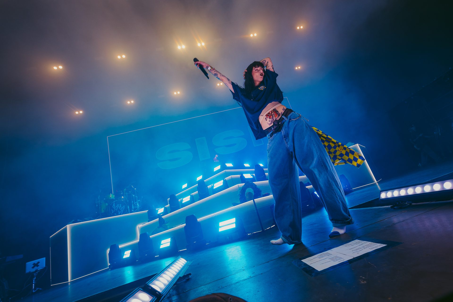 Wide shot of the Budapest Park stage lit in blue